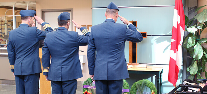 Veterans saluting a cross at Deer lodge Centre